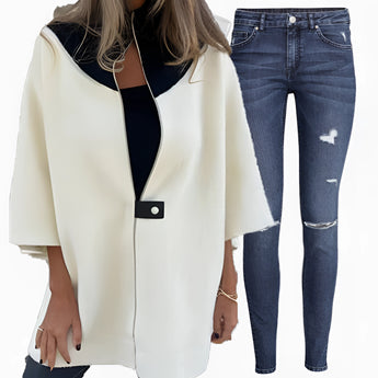 Elegant women's luxury white wool cape with a tailored fit, featuring a classic collar and long sleeves, designed for winter wear.