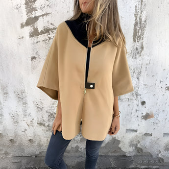Elegant white wool cape for women, showcasing a stylish winter fashion coat with a high collar and structured shoulders, featuring long sleeves and a tailored waist for a sophisticated look.