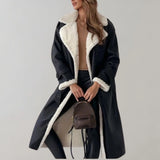 Luxury women's black leather coat with shearling lining, featuring a classic overcoat design with a notched collar, tailored waist, full-length sleeves, and knee-length hem.
