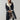 Luxury women's black leather coat with shearling lining featuring a knee-length design, tailored waist, and a cozy collar.