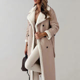 Luxury women's black leather coat with shearling lining, featuring a stylish overcoat design, long sleeves, and paired with a fashionable fedora hat.