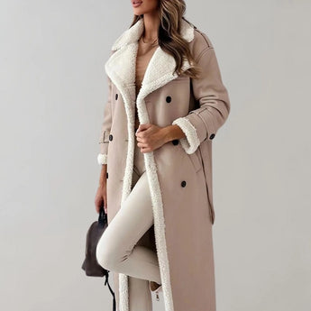 Luxury women's black leather coat with shearling lining, featuring a stylish overcoat design, long sleeves, and paired with a fashionable fedora hat.