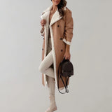 Luxury women's black leather coat with shearling lining, featuring a stylish collar and knee-length design.