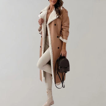 Luxury women's black leather coat with shearling lining, featuring a stylish collar and knee-length design.
