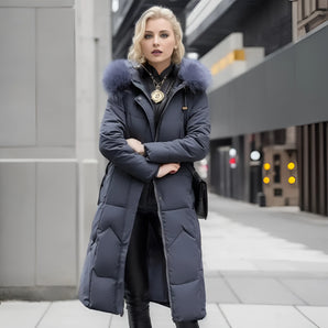 Luxury women's designer down jacket featuring a fur hooded parka coat design, in a stylish grey color. The jacket includes a sophisticated collar, long sleeves, and a fitted waist, with a length that extends to the thighs.