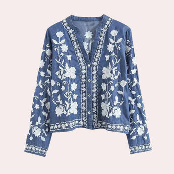 Luxury women's blue floral embroidered denim bell sleeve top in size XL, featuring intricate floral detailing, a round neckline, and distinctive bell sleeves.