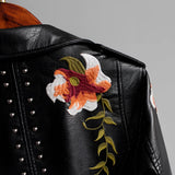 Luxurious women's leather jacket featuring intricate floral embroidery, with long sleeves and a stylish collar, showcasing designer embellishments.