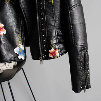 Luxury women's leather jacket featuring intricate floral embroidery, with a classic collar and long sleeves, showcasing a blend of fashion design elements.