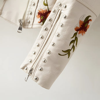 Luxury women's leather jacket featuring intricate floral embroidery, showcasing a designer touch with detailed flowers along the sleeves and collar.