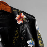 Luxurious women's leather jacket featuring intricate floral embroidery, with a focus on the sleeves and collar, presented in an electric blue hue.
