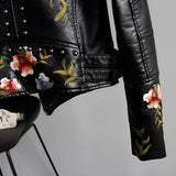 Luxury women's floral embroidered designer leather jacket with a stylish collar and detailed pattern, featuring long sleeves and button closure.