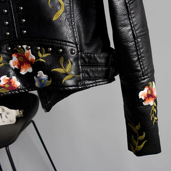 Luxury women's floral embroidered designer leather jacket with a stylish collar and detailed pattern, featuring long sleeves and button closure.