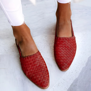 Luxury women's handcrafted red woven leather loafers, size 43, paired with blue jeans, ideal for stylish office wear.