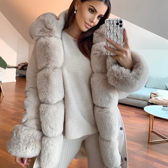 Luxury women's oversized faux fur winter coat featuring a plush texture and elegant design, highlighting the collar and sleeves. The coat showcases a fashionable, comfortable fit that extends to the waist and thighs, suitable for enhancing winter wardrobes.