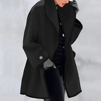 Luxury women's purple wool coat with an oversized fit, featuring a fashionable design and contrast lining, displayed in a jet black color variant, size 3XL. The coat has a structured collar and long sleeves, resembling a trench coat style, highlighting its elegant and trendy appearance.