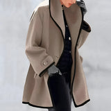 Luxury women's oversized purple wool coat with contrast lining, featuring a stylish collar, long sleeves, and fashionable design elements reminiscent of a trench coat. The coat is displayed on a mannequin, highlighting its elegant silhouette and quality craftsmanship.