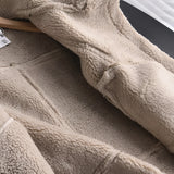 Luxury women's tan suede faux fur winter jacket displayed close-up, highlighting the rich textile texture and soft faux fur lining on the sleeves, against a neutral background.
