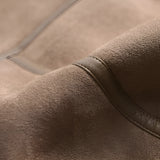 Luxury women's tan suede faux fur winter jacket featuring beige and grey hues with a close-up view of the sleeve and jacket pattern.