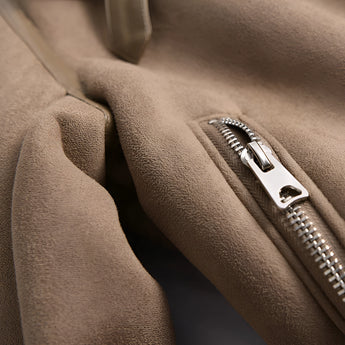 Luxury women's tan suede faux fur winter jacket featuring a stylish design with long sleeves in a soft beige color, depicted in an automotive setting.