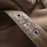 Luxury women's tan suede winter jacket with faux fur collar and long sleeves, displayed on a wooden background.