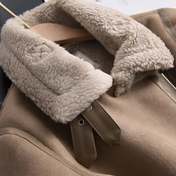 Luxury women's tan suede faux fur winter jacket featuring long sleeves and a cozy design, with an emphasis on comfort and warmth. The jacket is styled with natural materials and has a soft, grey faux fur lining for added elegance and insulation against cold weather.