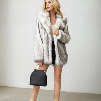 Luxurious women's faux fur coat in white and gray, featuring a stylish collar and long sleeves, perfect for winter fashion.