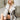 Luxury women's white and gray faux fur coat modeled in a winter fashion setting, showcasing the coat's luxurious texture and design, with focus on the sleeves and waist, captured in flash photography.