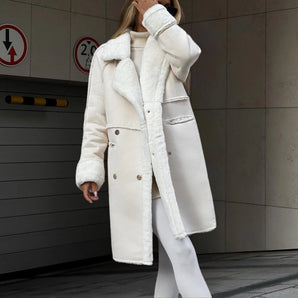 Luxury women's white shearling long winter coat featuring a sleek overcoat design, emphasizing the neck and waist with elegant sleeves, made from natural materials, ideal for fashion-forward winter outerwear.