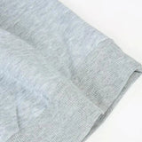 Grey textured fabric hoodie in size M, featuring long sleeves and a lightweight design, suitable for casual wear.