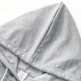 Gray textured fabric hoodie in size M, featuring long sleeves and a casual design, suitable for lightweight outerwear. The hoodie is comfortable and has a simple collar, ideal for everyday fashion.