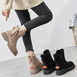 
Women's cozy winter ankle boots with fur lining, featuring a slip-resistant sole, shown in a black and white color scheme.