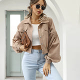 Maroon cropped women's suede jacket displayed with a trendy casual fashion style, featuring a khaki color in an XL size. The jacket is paired with accessories such as sunglasses, highlighting its fashionable appeal.