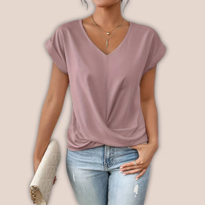 Mauve V-neck blouse in a casual chic style, featuring a relaxed fit and short sleeves, paired with jeans, showcasing summer fashion for plus-size women.