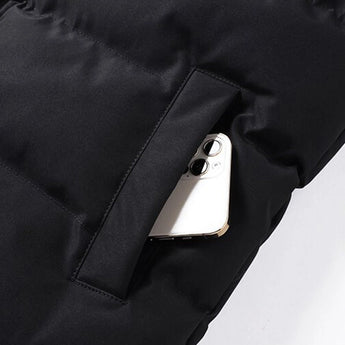 Men's beige fleece vest featuring an insulated collar and pockets, displayed against a neutral background.