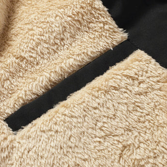 Men's beige fleece vest with insulated collar and pockets displayed on a grassy outdoor surface.