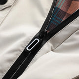 Men's beige hooded windbreaker jacket with long sleeves, displayed on a hanger, showcasing its lightweight design ideal for spring.