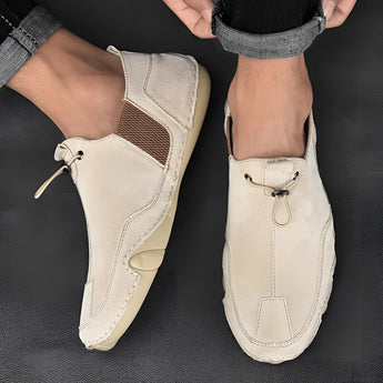 Men's beige suede slip-on loafers displayed in casual and breathable design, showcasing natural material and fashion accessory elements with no visible pattern, in size 47.