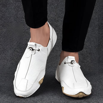 Men's beige suede slip-on loafers in a size 47, featuring a casual and breathable design with a white color variant, shown on a human leg.
