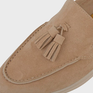 Men's beige tassel suede loafers with a moc-toe design, featuring a luxury slip-on style in a soft suede material.