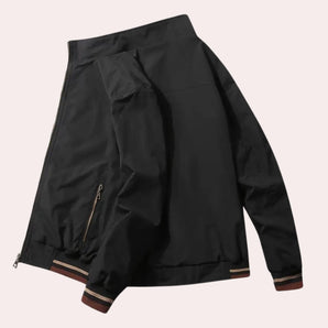 Men's black bomber jacket with zipper sleeve details, featuring a sleek collar and pockets, designed for urban fall wear.
