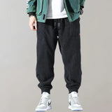Men's black corduroy cargo pants with ankle tapering, urban style, size 3XL, featuring multiple pockets and a sleek design.
