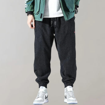 Men's black corduroy cargo pants with ankle tapering, urban style, size 3XL, featuring multiple pockets and a sleek design.
