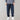 Men's black corduroy cargo pants with an ankle-tapered fit, styled urbanly, paired with a dark blue dress shirt.
