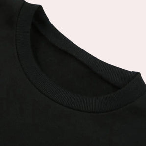 Men's black crew neck cotton t-shirt laid flat, showcasing short sleeves and soft, durable fabric.