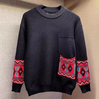 Men's black crewneck sweater featuring ethnic pattern sleeves with intricate designs, showcasing a mix of black, white, and grey textiles.