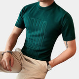 Men's green designer style t-shirt in size 3XL featuring an embossed logo, ribbed cuffs, and a comfortable fit displayed on a mannequin or model.