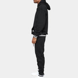 Men's black hoodie and joggers set in fleece fabric, showcasing stylish streetwear design with long sleeves and a comfortable waist fit.