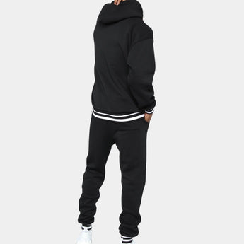 Men's black hoodie and joggers set in fleece material, showcasing a stylish streetwear design with long sleeves and a comfortable waist fit.