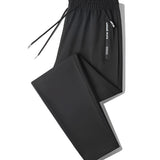 Men's black joggers in a lightweight fabric, designed for athletic use. The pants feature zippered pockets and are shown in a 4XL size.