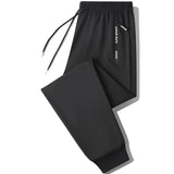 Men's black joggers showcasing lightweight design with zippered pockets, suitable for athletic activities.